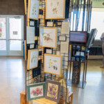 This is the new rack and small works exhibit "Seeds: The Foundation of Life, Hope for the Future". Framed art is the exhibit. Unframed prints at the bottom are for sale and not part of the exhibit.